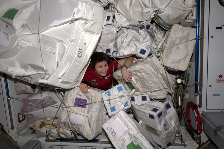 Italian astronaut Samantha Cristoforetti amid packages destined for the outgoing Dragon capsule.