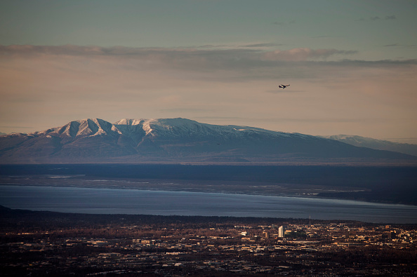 An airplane flies over Cook Inlet in Anchorage, Alaska, U.S., on Wednesday, Nov. 5, 2014.  