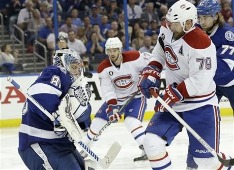 Tampa Bay Lightning goalie Andrei Vasilevskiy, left, of Russia, makes a save against Montreal Canadiens defenseman Andrei Markov, right, of Russia, during third period of Game 4 NHL second round playoff hockey action, Thursday, May 7, 2015, in Tampa, Fla. The Canadiens defeated the Lightning 6-2. 