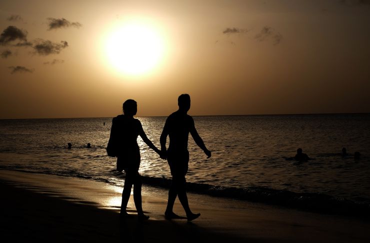 A couple take a stroll along a beach in Saint George's, Grenada, on April 20, 2015. 