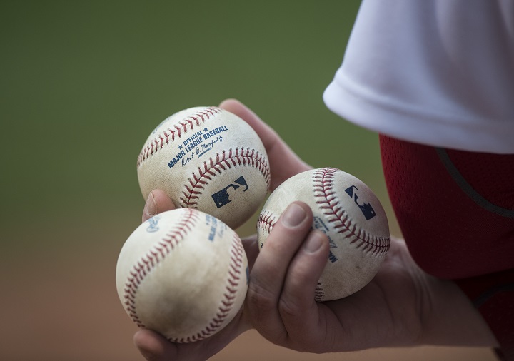 A ball boy has baseballs at the ready during the first inning between the Boston Red Sox and Toronto Blue Jays at Fenway Park in Boston, Massachusetts on April 29, 2015.