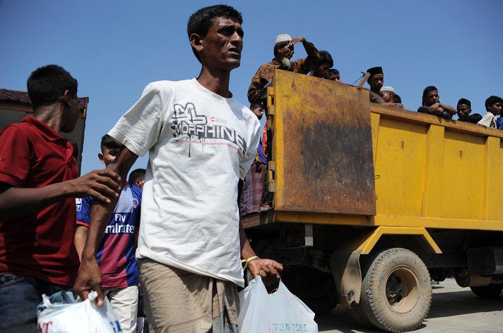 Rescued migrants, mostly Rohingyas from Myanmar and Bangladesh, arrive at the fishing port of Kuala Cangkoi in Aceh province on May 13, 2015, after the migrants numbering nearly 600 were relocated by Indonesian authorities from a government sports stadium. Malaysia joined Indonesia on May 13 in vowing to turn back vessels bearing a wave of migrants, drawing warnings that the hardline policy could be a death sentence for boatloads of people at risk of starvation and disease.  