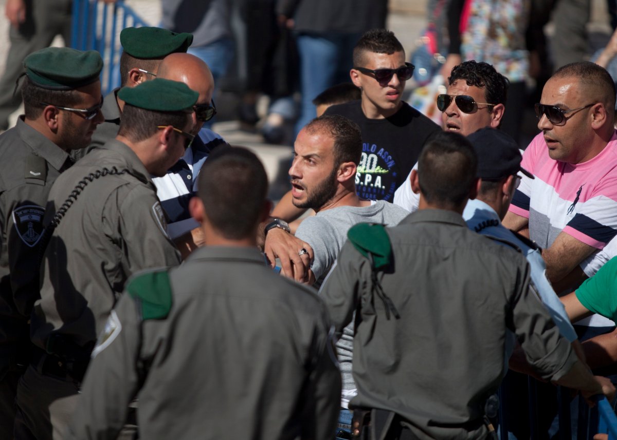 Israeli border policemen detain a Palestinian man as Israelis march marking Jerusalem Day on May 17, 2015 outside Jerusalem's old city, Israel.