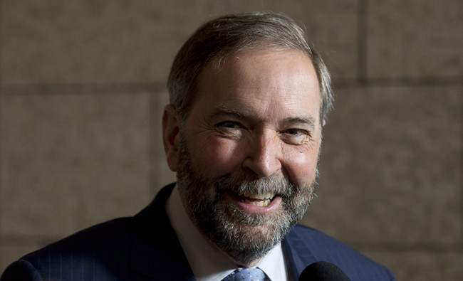 NDP leader Tom Mulcair smiles as he speaks with reporters following party caucus on Parliament Hill Wednesday, May 6, 2015 in Ottawa.