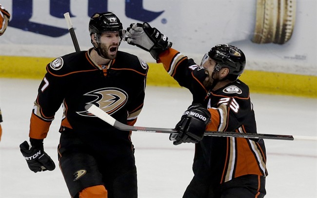 Anaheim Ducks center Ryan Kesler celebrates after scoring with defenseman Francois Beauchemin against the Calgary Flames during the second period of Game 5 in an NHL hockey second-round playoff series in Anaheim, Calif., Sunday, May 10, 2015. 