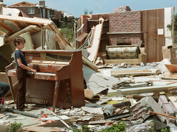 Kevin Shaw takes a break amidst the ruins of his home in Barrie, Ont., on June 2, 1985.