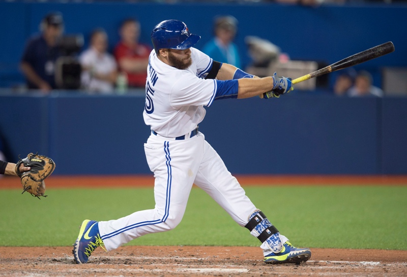 Toronto Blue Jays' Russell Martin hits a pinch-hit RBI single during eighth inning MLB baseball action against the New York Yankees in Toronto on Monday, May 4, 2015. 