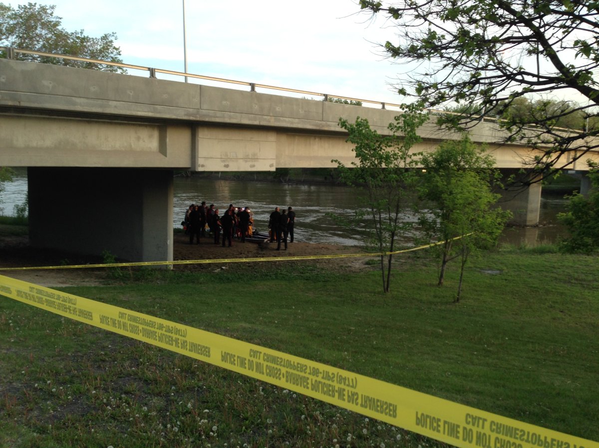 Winnipeg water rescue teams recover a body from the Assiniboine River late Wednesday evening.