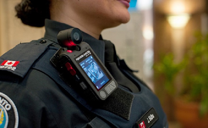 A Toronto police officer displays a body-worn camera at police headquarters.