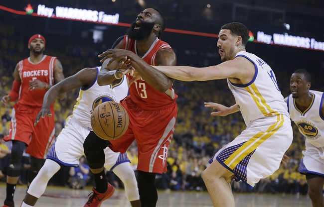 Golden State Warriors' Klay Thompson, right, fouls Houston Rockets' James Harden (13) during the first quarter of Game 1 of the NBA basketball Western Conference finals Tuesday, May 19, 2015, in Oakland, Calif.