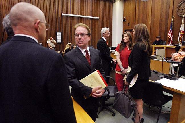 Alix Tichelman, in red, acknowledges her parents as she is surrounded by lawyers on Tuesday, May 19, 2015, in Santa Cruz, Calif.