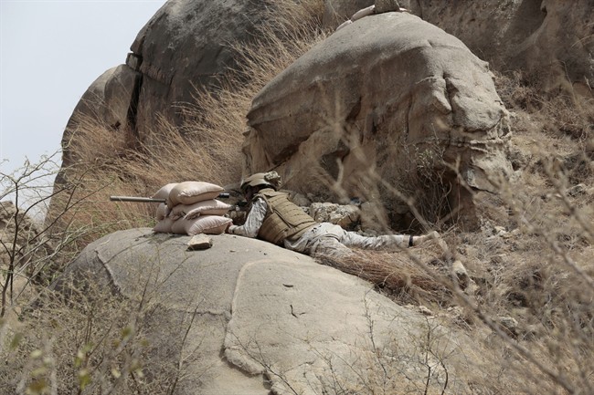 In this Monday, April 20, 2015 file photo, a Saudi soldier aims machine-gun from behind sandbag barricade in the border with Yemen in Jazan, Saudi Arabia.
