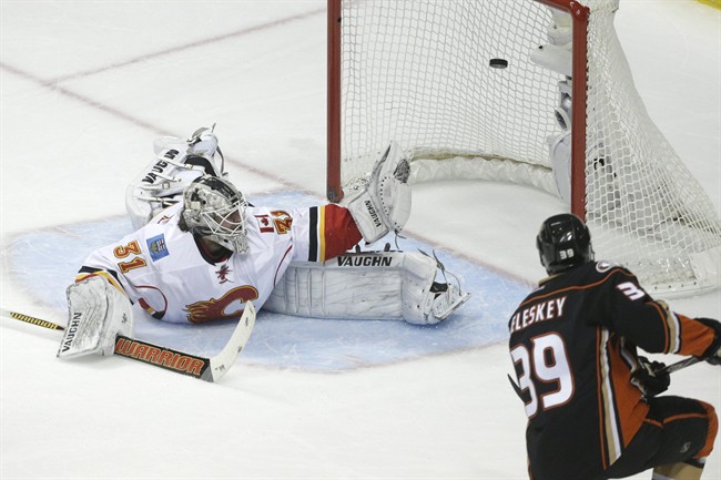 Anaheim Ducks' Matt Beleskey, right, scores against Calgary Flames goalie Karri Ramo, of Finland, during the first period of Game 2 in the second round of the NHL Stanley Cup hockey playoffs, Sunday, May 3, 2015, in Anaheim, Calif.