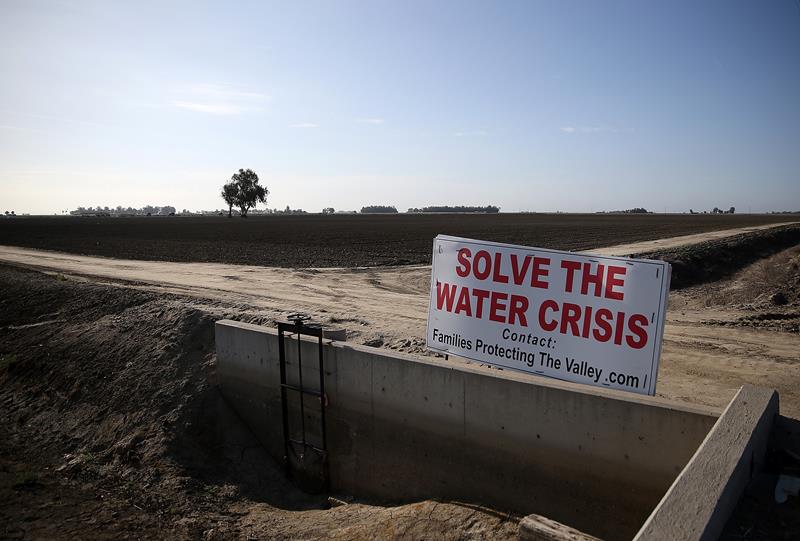 A sign referencing the drought is posted next to a fallow field on April 24, 2015 in Lemoore, California.