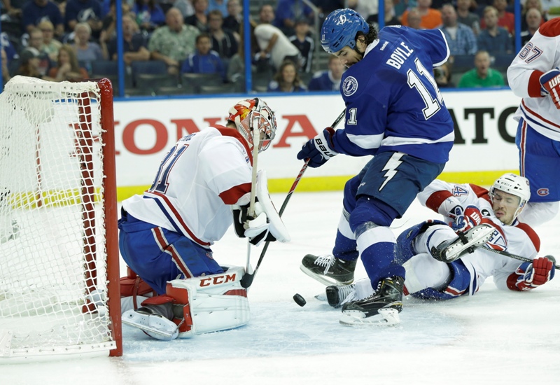 Tampa Bay Lightning center Brian Boyle (11) attempts a shot between Montreal Canadiens goalie Carey Price (31) and defenseman Alexei Emelin of Russia, right, during second period of Game 3 NHL second round playoff hockey action, Wednesday, May 6, 2015, in Tampa, Fla. 