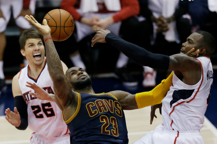 Cleveland Cavaliers forward LeBron James (23) loses the rebound as Atlanta Hawks guard Kyle Korver (26) and Atlanta Hawks forward Paul Millsap (4) look on during the second half in Game 1 of the Eastern Conference finals of the NBA basketball playoffs, Wednesday, May 20, 2015, in Atlanta. 