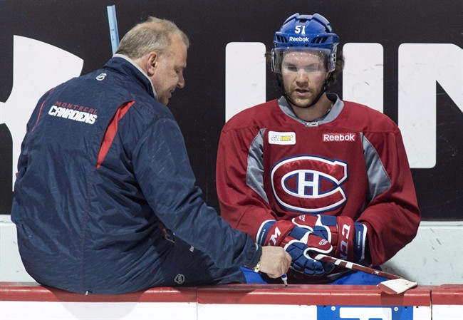 Montreal Canadiens head coach Michel Therrien, left, gives a few pointers to David Desharnais during a practice Monday, April 13, 2015.