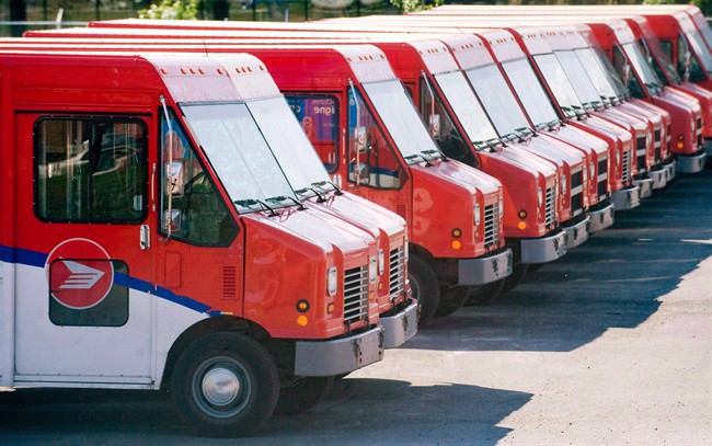 Canada Post vehicles sit outside a sorting depot in the Ville St-Laurent borough of Montreal on June 6, 2011.