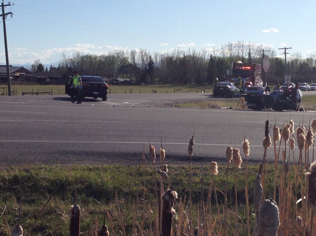 Two people sent to hospital after motorcycle and car crash at Springbank intersection - image