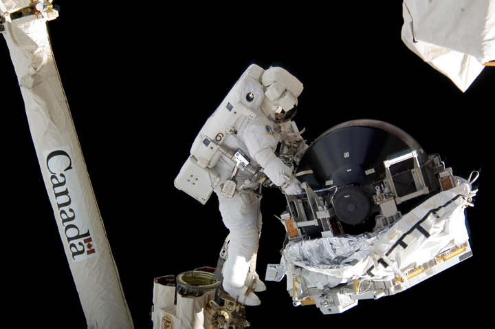Canadian astronaut Dave Williams is seen working on the Canadarm during a spacewalk in 2007. Astronauts like Williams currently rely on diapers during such excursions.