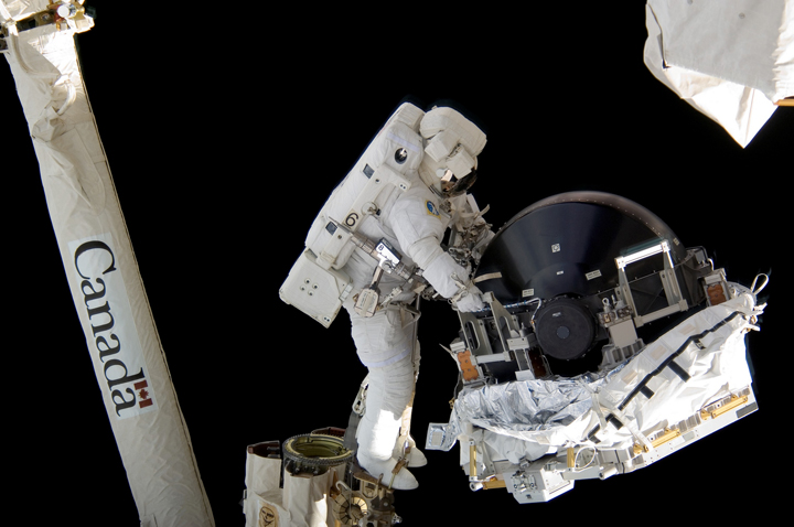 Canadian astronaut Dave Williams is seen here together with the Canadarm during a spacewalk in 2007.