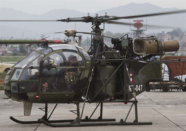 A Nepalese army chopper lands at the airport in Kathmandu, Nepal, Friday, May 15, 2015.