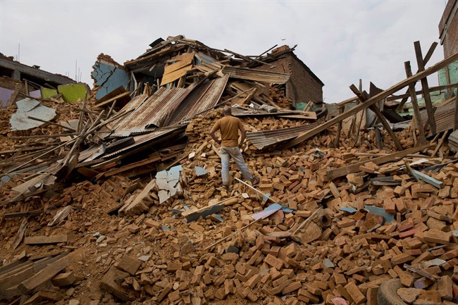 A man inspects an area that collapsed during the May 12 earthquake in Chautara, Nepal, Wednesday, May 13, 2015. Nepal, just beginning to rebuild after a devastating April 25 earthquake, was hit by a magnitude-7.3 quake Tuesday. (AP Photo/Bernat Amangue).