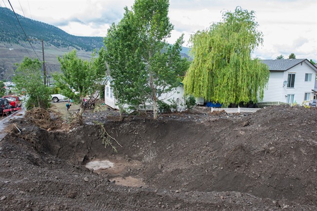 Property damage is shown after flash flooding in Cache Creek, B.C., Monday, May 25, 2015.