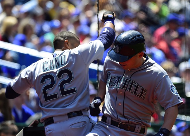 Seattle Mariners' Kyle Seager, right, celebrates a solo home run with teammate Roninson Cano, 22, during the second inning of American League baseball action against the Toronto Blue Jays in Toronto on Saturday, May 23, 2015.