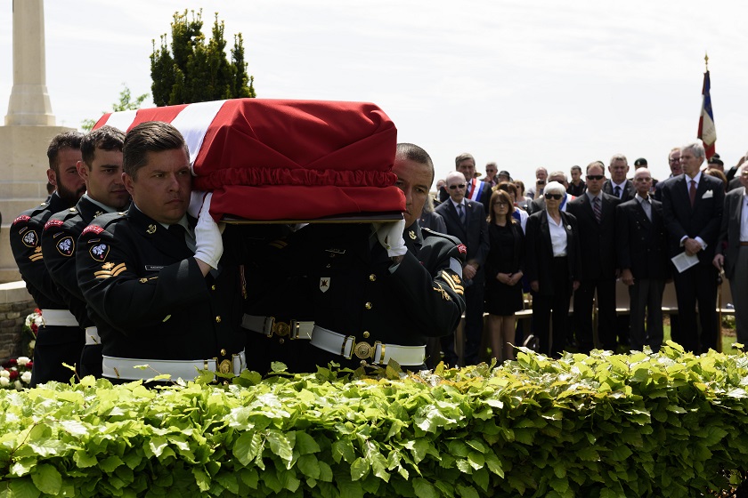 Members of the burial party from the Second Battalion Princess Patricia's Canadian Light Infantry carry an unknown soldier to his final resting place.