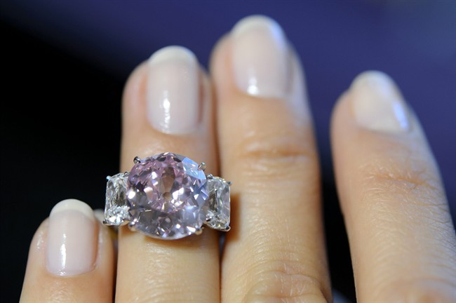 A Sotheby's employee shows ''the Historic Pink'', a ring with a fancy vivid pink diamond weighing 8.72 carats and with a classic non-modified cushion cut, which is estimated to sell between 14,000,000 to 18,000,000 US dollar, during a preview at the Sotheby's auction house in Geneva, Switzerland, Wednesday, May 6, 2015. The auction will take place in Geneva on May 12, 2015. 