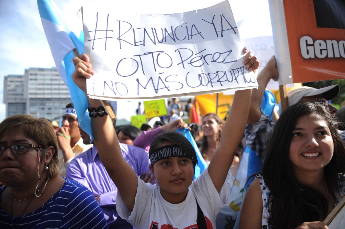 People take part in a demonstration demanding that Guatemalan President Otto Perez step down due to a corruption scandal that has shaken his government to its core, in Guatemala City on May 30, 2015. 