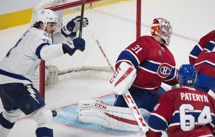 Montreal Canadiens goaltender Carey Price and defenceman Greg Pateryn look down as Tampa Bay Lightning's Brian Boyle celebrates teammate Nikita Kucherov's game winning goal during the second overtime period of Game 1 NHL second round playoff hockey action in Montreal, Friday, May 1, 2015.