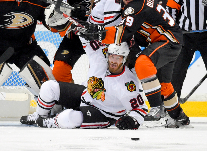Chicago Blackhawks left wing Brandon Saad looks at the pucks while under pressure from the Anaheim Ducks during the second period of Game 2 of the Western Conference final during the NHL hockey Stanley Cup playoffs in Anaheim, Calif., on Tuesday, May 19, 2015. 