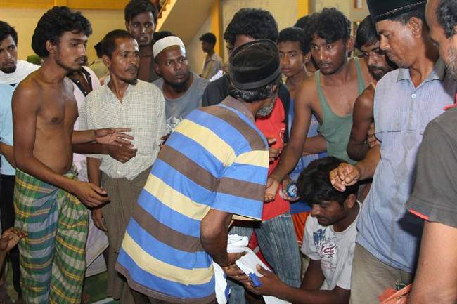 Ethnic Rohingya migrants queue up to receive clothing at a temporary shelter in Lhok Sukon, Aceh province, Indonesia, Monday, May 11, 2015.