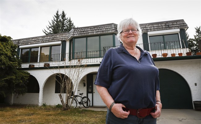 Mary Eggermont-Molenaar, standing in front of her Calgary, Alta., home on Saturday, April 18, 2015, has been told she's living in the first home of U.S. Sen. Ted Cruz by an old family friend. She'd rather not own a historical property, if it means he'd become president. 