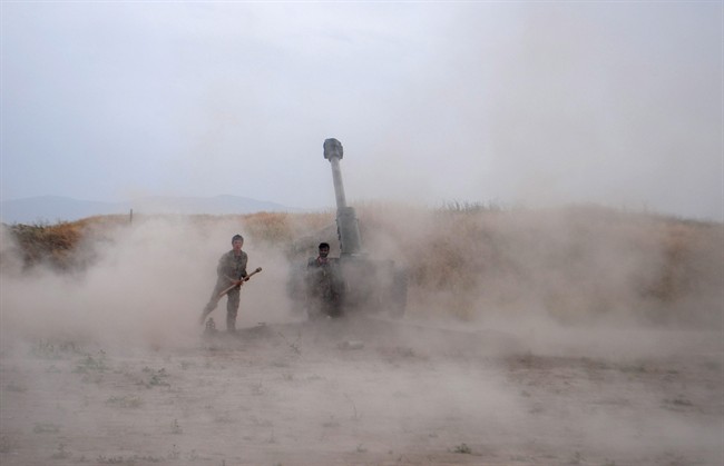 Afghan National Army soldiers fire artillery during a battle with Taliban insurgents in the Chahardara district of Kunduz province north of Kabul, Afghanistan, Sunday, May 3, 2015. 
