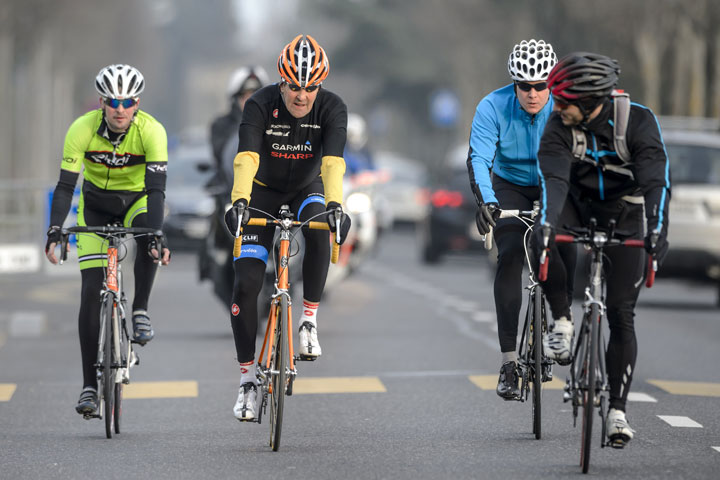 US Secretary of State John Kerry (2nd L) rides his bike with bodyguards during a break on Iran talks on March 16, 2015 in Lausanne.