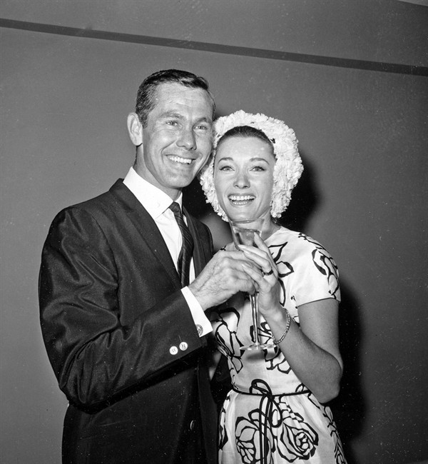 This Aug. 17, 1963 file photo shows comedian Johnny Carson and his bride, former television personality and model Joanne Copeland, at a reception in his apartment after their wedding in New York.