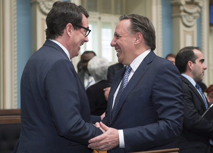 Quebec Second Opposition Leader François Legault, right, greets Quebec Opposition Leader Pierre Karl Péladeau as he enters the legislature for question period Tuesday, May 19, 2015 in Quebec City.