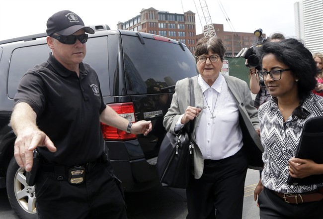 A member of the Boston Police Bomb Squad points the way for death penalty opponent Sister Helen Prejean, center, as she leaves federal court in Boston after testifying during the penalty phase in Dzhokhar Tsarnaev's trial Monday, May 11, 2015.