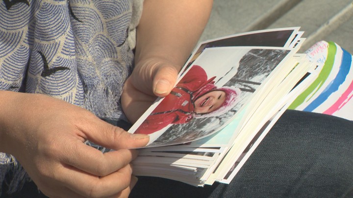 Mai Duong shows Global reporter Rachel Lau photos of her daughter, Alice.