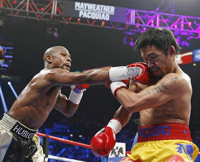 Floyd Mayweather Jr., left, connects with a right to the head of Manny Pacquiao during their welterweight title fight on Saturday, May 2, 2015 in Las Vegas. r.