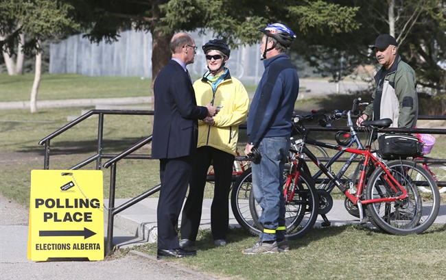 Voters gather early at Bishop Pinkham Junior High School in Calgary, Tuesday, May 5, 2015.