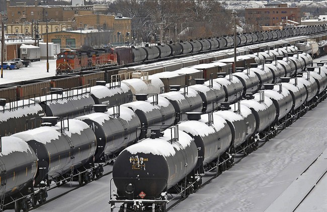In this Dec. 31, 2013 file photo, oil cars are backed up in a yard in the aftermath of a train derailment in Mandan, N.D. 