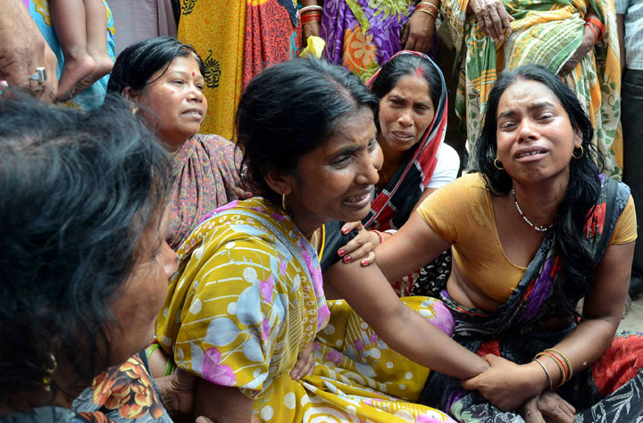 An Indian widow is comforted by relatives and friends after the death of her husband on the outskirts of Patna on May 12, 2015, after a new 7.3 earthquake and several powerful aftershocks hit neighbouring devastated Nepal.