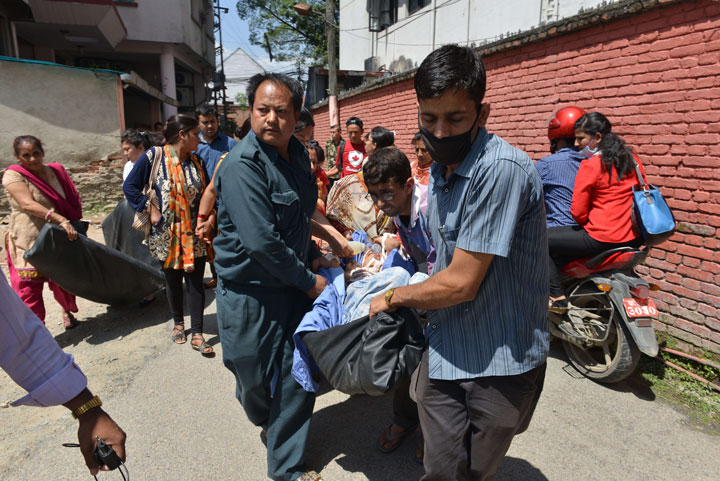 Nepalese patients are carried out of a hospital building as a 7.3-magnitude earthquake hits the country, in Kathmandu on May 12, 2015.
