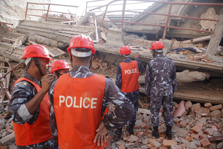 A Nepalese rescue team inspects the site of a building that collapsed in an earthquake in Kathmandu, Nepal, Tuesday, May 12, 2015.