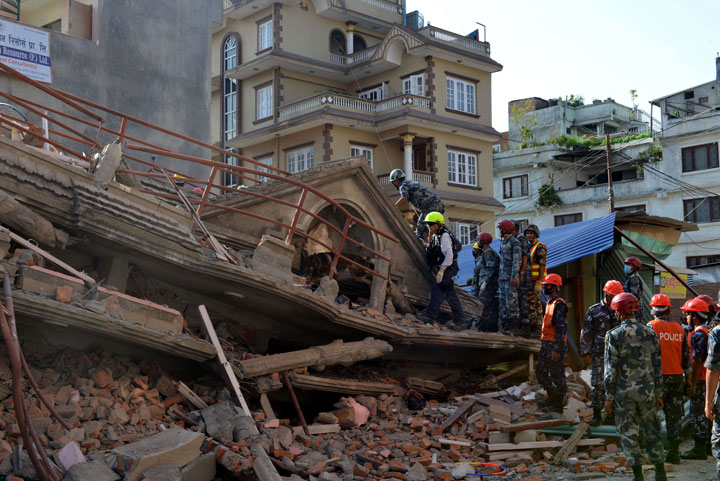 U.S. rescue team officials search for survivors at a collapsed house in Kathmandu May 12, 2015.