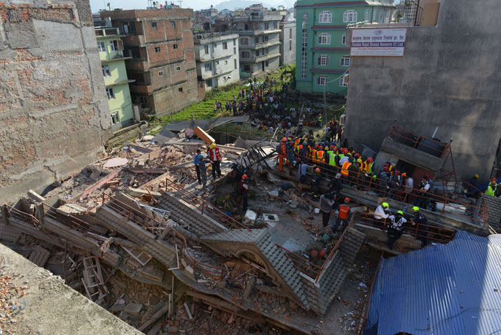 Rescue team officials search for survivors at a collapsed building in Kathmandu May 12, 2015.